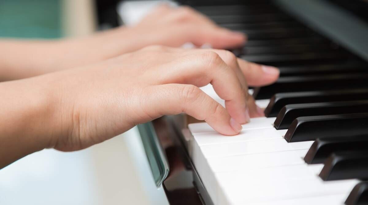 Close up of woman hands  playing piano